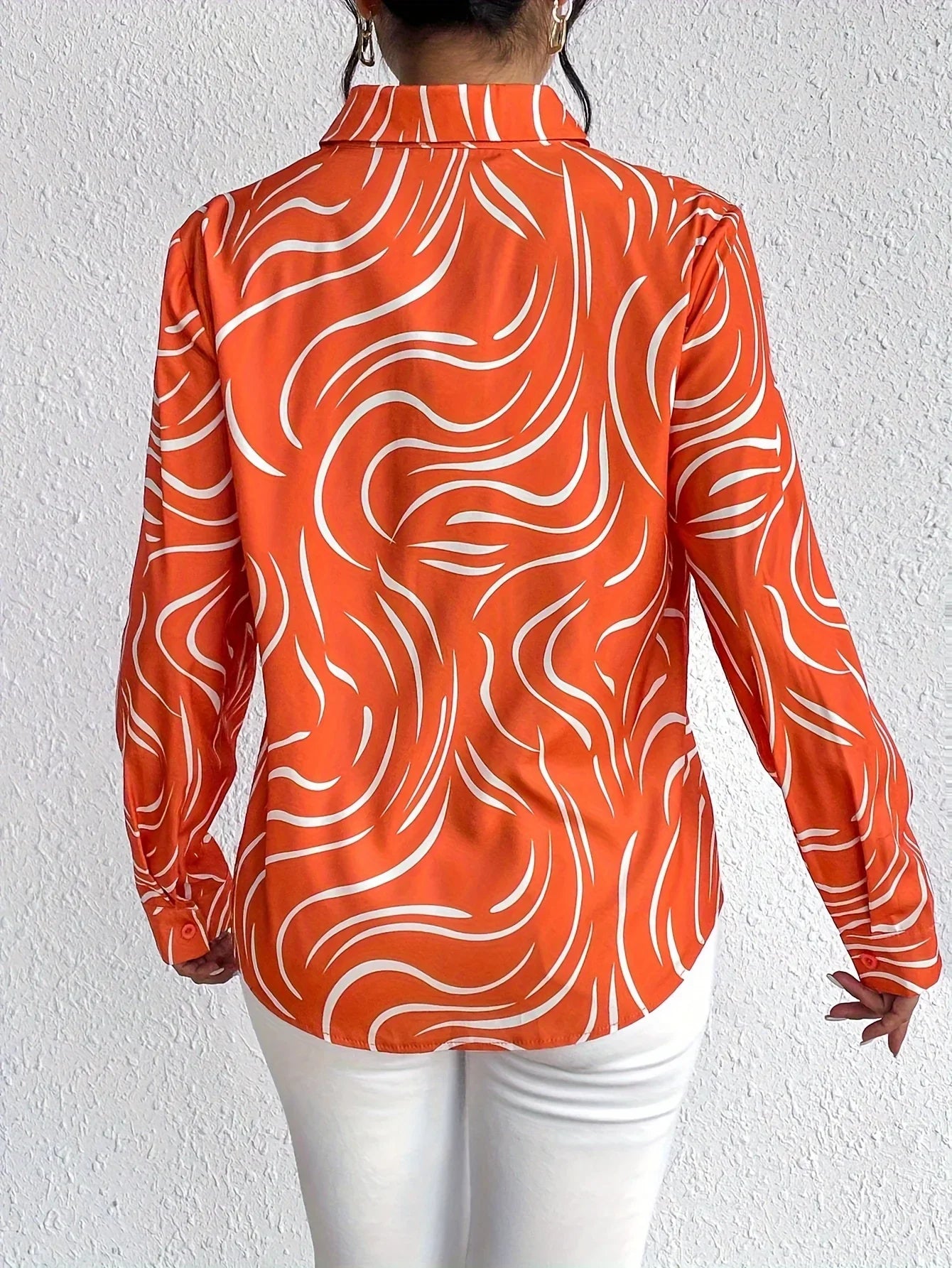 Oranje blouse met abstracte print
