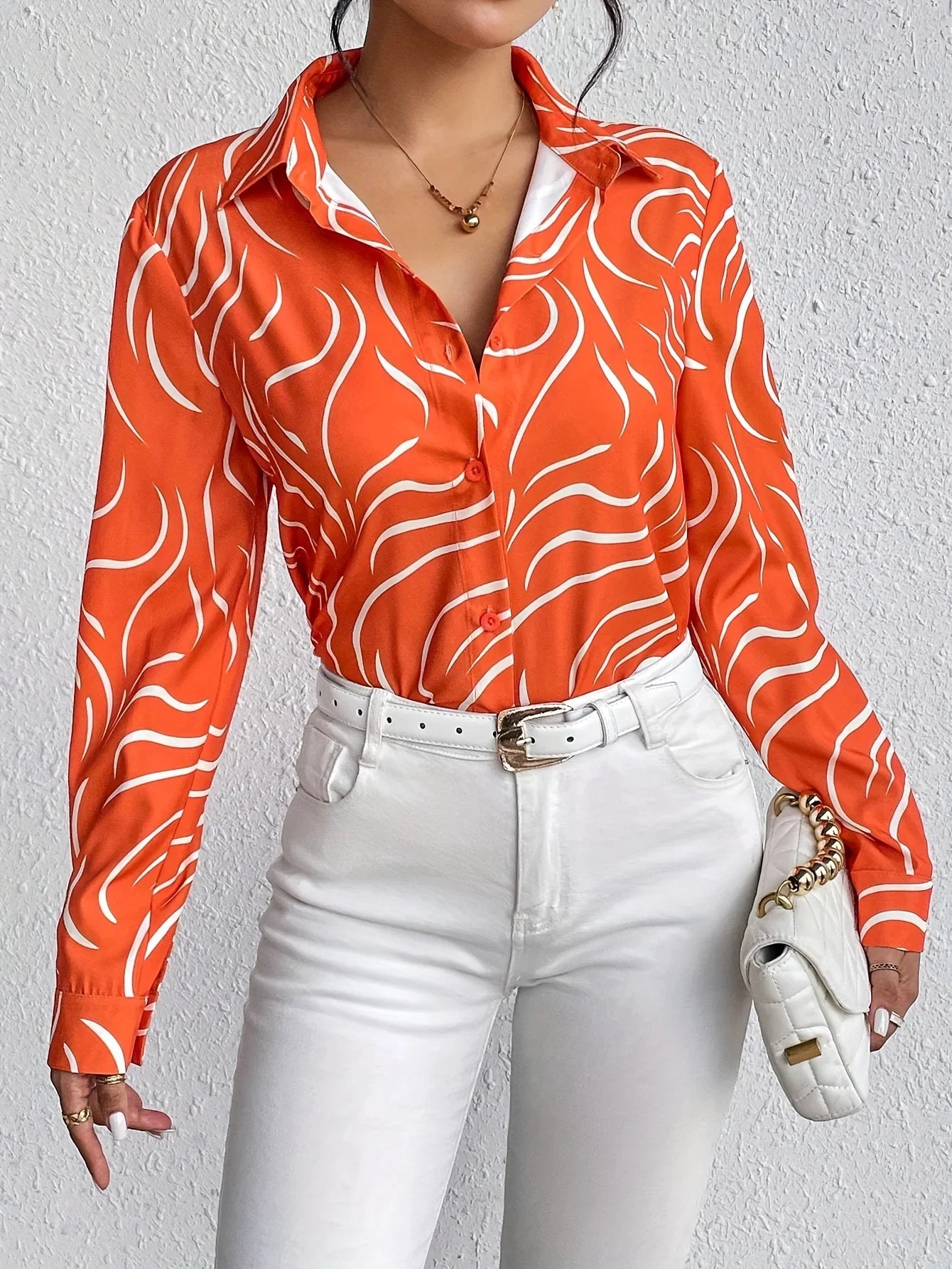 Oranje blouse met abstracte print