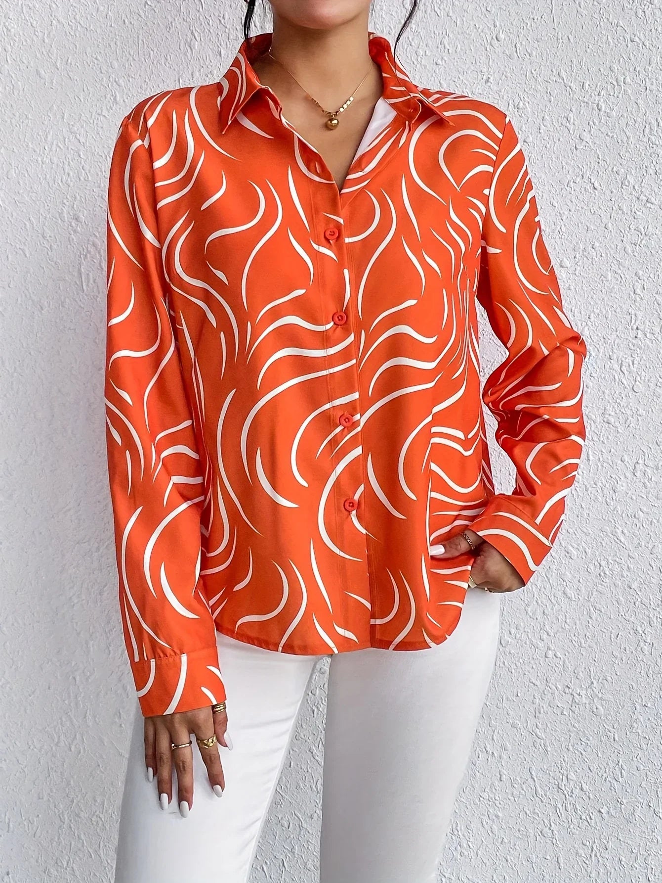 Oranje blouse met abstracte print